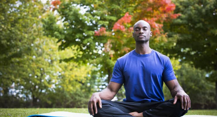 Man practicing mindfulness in nature to help cause epigenetic changes that affect the course of Gaucher disease.